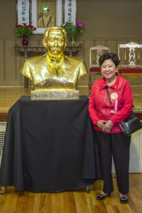Dr. Lily Sun beside statue